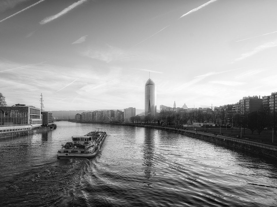 A river winding through a city in black and white