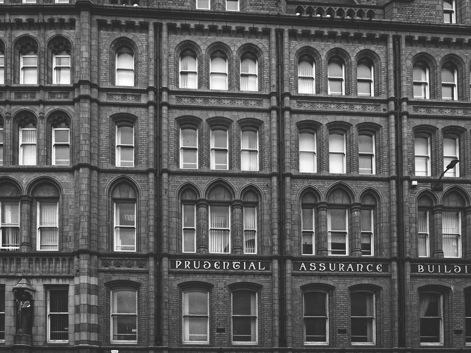 The facade of an old city building in black and white