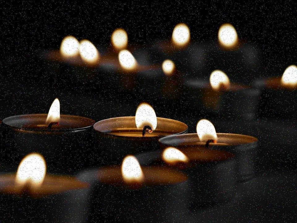 Rows of small candles glowing in the dark