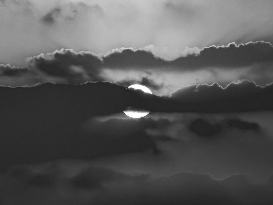 A dark sea under heavy clouds in black and white