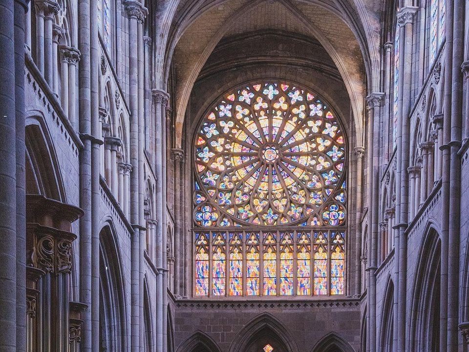 The vaulted interior of a cathedral with tall windows