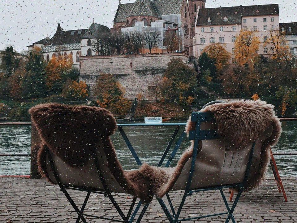 Two empty chairs facing a city street